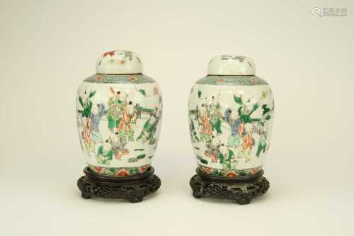 A pair of Chinese famille verte style jars and covers, Qing Dynasty, 19th century