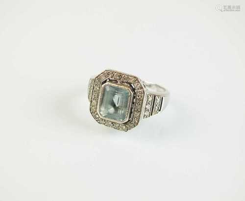 An Art Deco style 18ct white gold aquamarine and diamond cluster ring