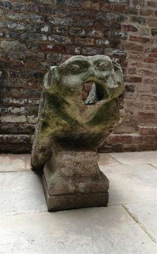 Two English sculpted limestone architectural masks or water spouts