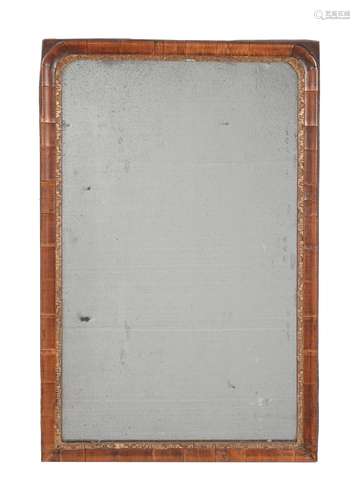 A George I walnut and parcel gilt wall mirror