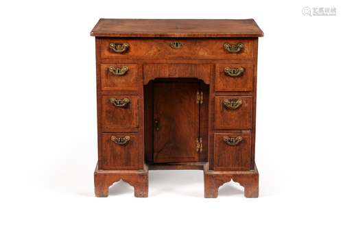 A George I walnut and feather banded kneehole desk