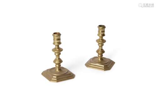 A pair of Queen Anne brass candlesticks