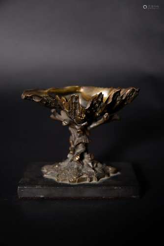 A patinated bronze table salt in the form of a clam shell