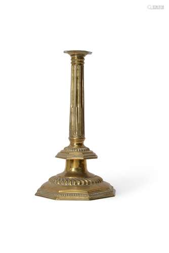 An impressive English repoussé brass columnar candlestick