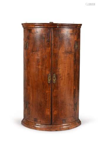 A George I walnut hanging corner cupboard