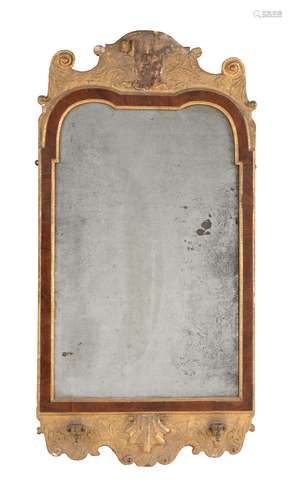 A George I gilt gesso, walnut and parcel gilt wall mirror