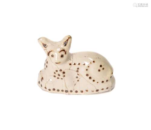 A Staffordshire creamware model of a recumbent cat