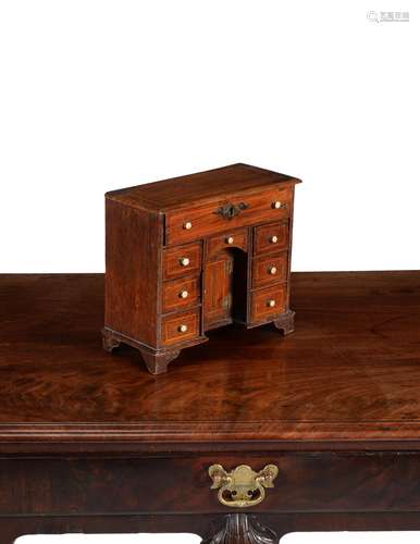 A walnut and line inlaid miniature kneehole desk