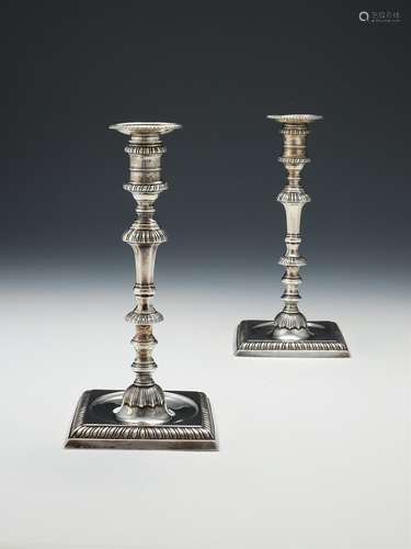 A pair of George III cast silver square candlesticks