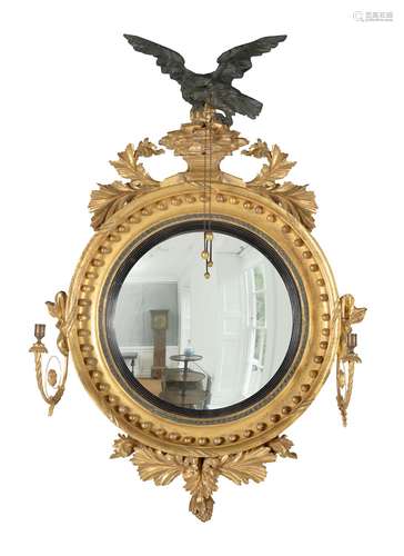 A George III giltwood convex girandole wall mirror