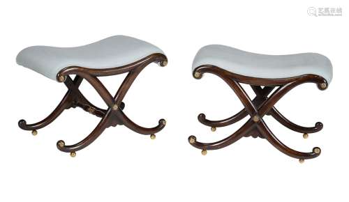 A pair of Regency ebonised and parcel gilt stools