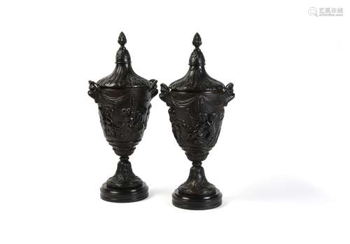 A pair of fine French patinated bronze urns and covers