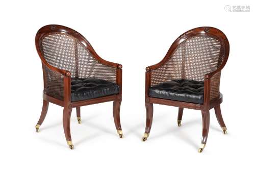 A pair of Regency mahogany library bergere or 'curricle' armchairs