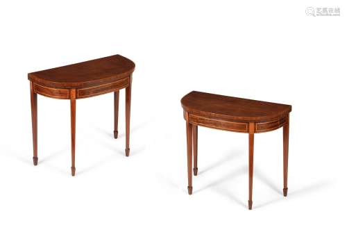 A pair of George III mahogany and satinwood folding card tables