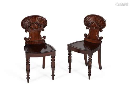 A pair of George IV mahogany hall chairs