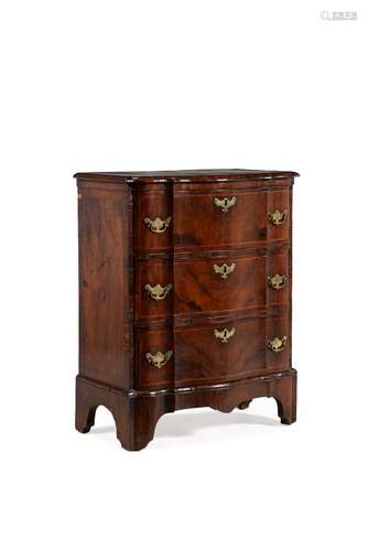 A walnut and feather banded serpentine fronted chest of drawers