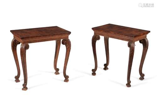 A matched pair of walnut and carved pine side tables