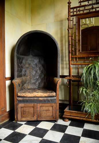 A mahogany and leather upholstered porter's chair