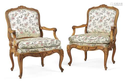 A pair of Louis XV carved beech and upholstered fauteuil