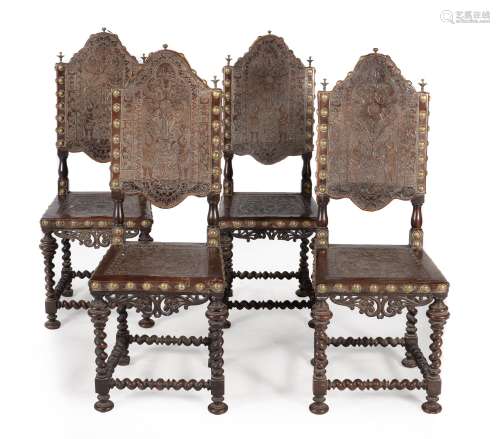 A set of four Iberian exotic hardwood and embossed leather upholstered chairs