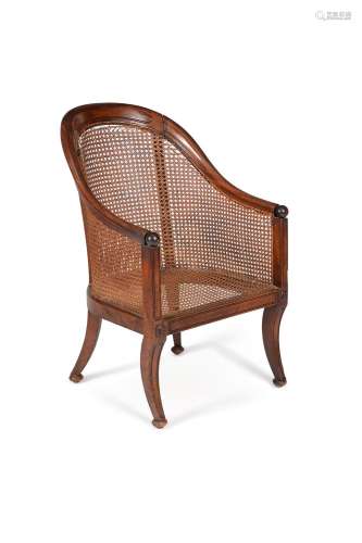 A Regency mahogany and caned library bergere armchair