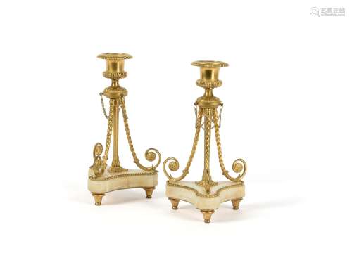 A pair of Napoleon III gilt bronze and onyx mounted candlesticks