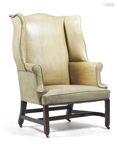 A George II mahogany and leather upholstered wing armchair