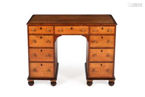 An early Victorian birch and yew kneehole desk