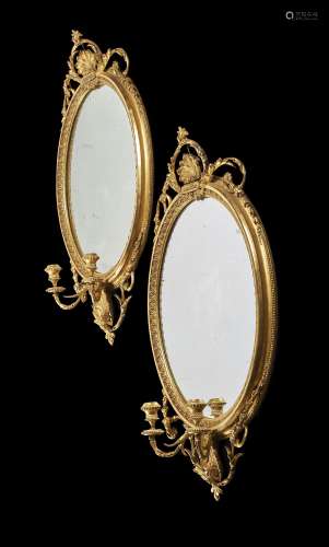 A pair of giltwood girandole wall mirrors, in George III style, late 19th century