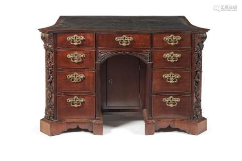 A George II mahogany serpentine kneehole desk