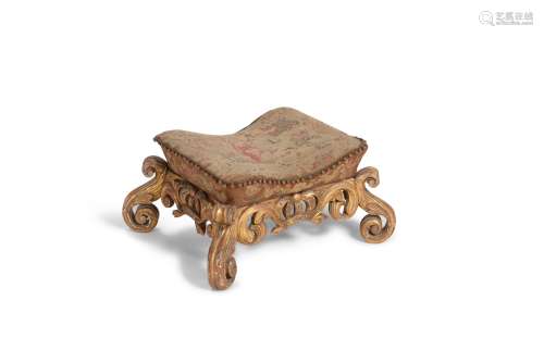 A carved giltwood and needlework upholstered foot stool