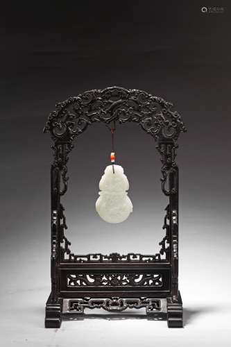 A WHITE JADE CARVED PLAQUE AND ZITAN FRAMED STAND