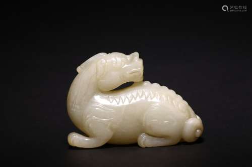 A CHINESE WHITE JADE CARVED FIGURE OF BIXIE