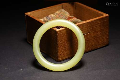 A YELLOW JADE CARVED BANGLE