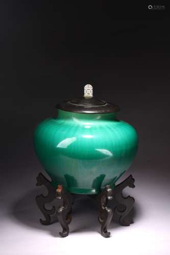 A GREEN GLAZED JAR WITH COVER