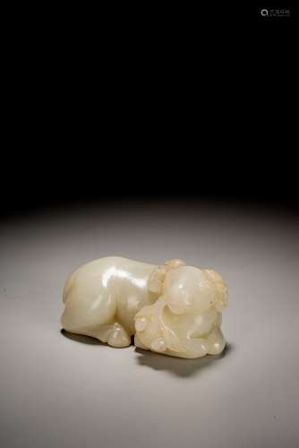 A CHINESE WHITE JADE CARVED SEATED RAM