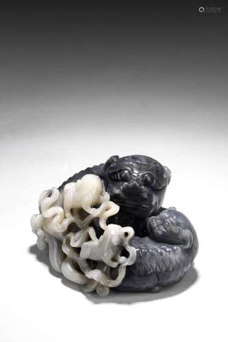 A LARGE BLACK AND WHITE JADE 'MYTHICAL BEASTS' GROUP