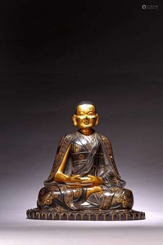 A ZITAN CARVED GILT INSCRIBED FIGURE OF SEATED GURU