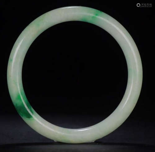 A JADEITE CARVED BANGLE