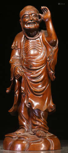 A HUANGYANG WOOD CARVED ARHAT SHAPE STATUE