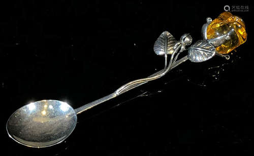 A SILVER CASTED SPOON WITH AMBER