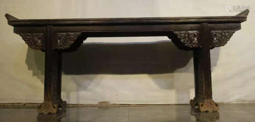A YUMU WOOD CARVED TABLE