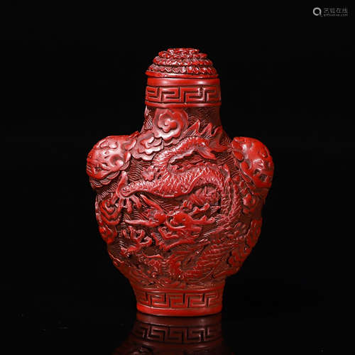 A CARVED RED LACQUERWARE DRAGON SNUFF BOTTLE WITH BEAST EARS