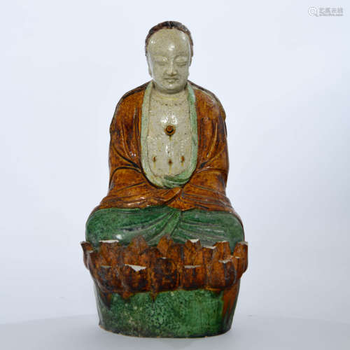 A PLAIN TRICOLOUR PORCELAIN BUDDHA STATUE