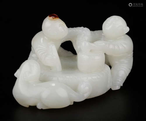 A HETIAN JADE CARVED CHILD SHAPED PENDANT