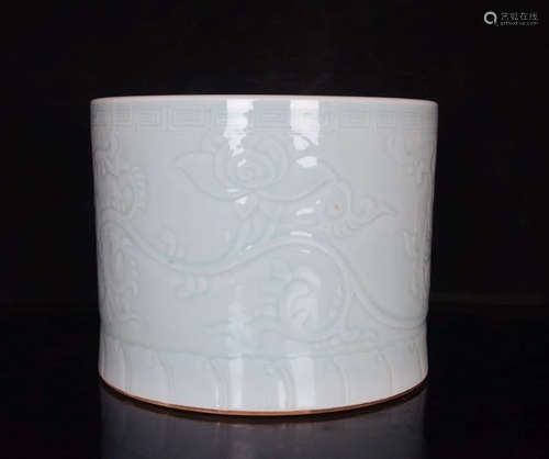 A Celadon-Glazed Interlocking Peony Carved Porcelain Brush Pot