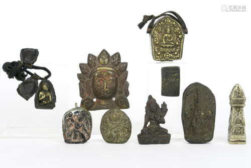 small collection of nine Tibeto-Nepalese amulets in bronze, stone or earthenware - [...]