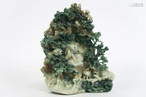 Chinese jade sculpture with a animated landscape with a reading god in a cave - - [...]