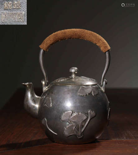 A SILVER CASTED LEAVES PATTERN LIFTING POT