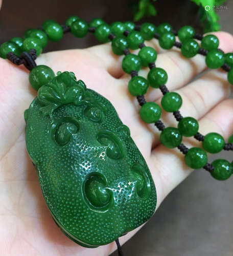 A JASPER CARVED AUSPICIOUS PATTERN PENDANT